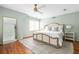 Bright bedroom featuring a large bed, wood floors, a large mirror, and a ceiling fan for added comfort at 956 Clifton Ne Rd, Atlanta, GA 30307