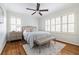 Serene bedroom with hardwood floors, plantation shutters, and a comfortable, stylish bed at 956 Clifton Ne Rd, Atlanta, GA 30307