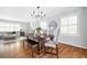 Elegant dining area features a wood table, chandelier lighting, and large windows with plantation shutters at 956 Clifton Ne Rd, Atlanta, GA 30307