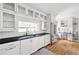Bright white kitchen featuring black countertops, stainless steel appliances and hardwood floors at 956 Clifton Ne Rd, Atlanta, GA 30307