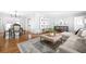A view of the open concept living room, dining room, and kitchen with hardwood floors and lots of light at 956 Clifton Ne Rd, Atlanta, GA 30307