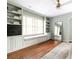 Charming living room featuring built-in shelves, window seat, and hardwood floors, creating a cozy and inviting atmosphere at 956 Clifton Ne Rd, Atlanta, GA 30307
