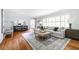 Bright living room featuring hardwood floors, neutral paint, large windows, and stylish furnishings at 956 Clifton Ne Rd, Atlanta, GA 30307