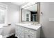 Bright bathroom featuring a dual sink vanity with marble countertop and a large framed mirror at 1916 Highway 138 Sw, Conyers, GA 30094