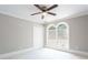 Bedroom featuring a ceiling fan, double windows, and white carpeting at 1916 Highway 138 Sw, Conyers, GA 30094
