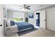 Cozy bedroom with a large window, ceiling fan, closet, and bathroom with black tile at 1916 Highway 138 Sw, Conyers, GA 30094