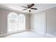Bedroom featuring a ceiling fan, double windows, and white carpeting at 1916 Highway 138 Sw, Conyers, GA 30094