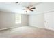 A cozy bedroom featuring a ceiling fan, natural light from the window, and a practical layout, perfect for relaxation at 1916 Highway 138 Sw, Conyers, GA 30094