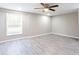 Bright bedroom with neutral paint, laminate flooring, ceiling fan and natural light offering a comfortable and versatile space at 1916 Highway 138 Sw, Conyers, GA 30094