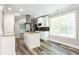 Modern kitchen with stainless steel appliances, granite countertops, and hardwood floors at 1916 Highway 138 Sw, Conyers, GA 30094
