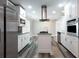 Well-lit kitchen features stainless steel appliances, white cabinets, granite countertops, dark backsplash, and hardwood floors at 1916 Highway 138 Sw, Conyers, GA 30094