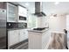 Modern kitchen features stainless steel appliances, white cabinets, dark backsplash, and center island with range at 1916 Highway 138 Sw, Conyers, GA 30094