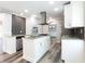 Bright kitchen with an island, stainless steel appliances, granite countertops, grey backsplash, and hardwood floors at 1916 Highway 138 Sw, Conyers, GA 30094