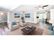Bright living room with hardwood floors, white trim, and ceiling fans at 1916 Highway 138 Sw, Conyers, GA 30094