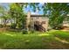 Expansive backyard with a deck, wooden stairs, mature trees, and a well-maintained lawn at 3570 Bardfield Ct, Cumming, GA 30041