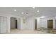 Bright basement featuring neutral walls, recessed lighting, and mixed flooring of carpet and stone tile at 3570 Bardfield Ct, Cumming, GA 30041