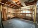 Unfinished basement with exposed ceiling and wooden shelving at 3570 Bardfield Ct, Cumming, GA 30041