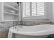 Close up of bathroom featuring a soaking tub with white marble surround at 3570 Bardfield Ct, Cumming, GA 30041