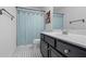 Charming bathroom features a shower with blue curtain and a vanity with ample storage at 3570 Bardfield Ct, Cumming, GA 30041