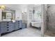Elegant bathroom featuring dual sinks, a soaking tub, and a separate walk-in shower at 3570 Bardfield Ct, Cumming, GA 30041