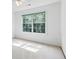 Sunlit room featuring a large window showcasing a view of lush trees at 3570 Bardfield Ct, Cumming, GA 30041