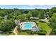 Aerial view of the community pool, surrounded by lush trees and green lawns at 3570 Bardfield Ct, Cumming, GA 30041