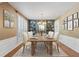 Charming dining room with classic wallpaper, a modern chandelier, and a large window for natural light at 3570 Bardfield Ct, Cumming, GA 30041