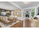 Elegant dining room with hardwood floors, chandelier lighting, and seamless access to the inviting living space at 3570 Bardfield Ct, Cumming, GA 30041
