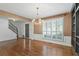 Elegant dining room featuring hardwood floors, wainscoting, and a chandelier at 3570 Bardfield Ct, Cumming, GA 30041