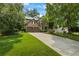 Home exterior shows a well-manicured lawn, mature trees, and a driveway leading to a two-car garage at 3570 Bardfield Ct, Cumming, GA 30041