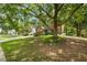 Charming front yard features a large shade tree and lush green grass, enhancing curb appeal at 3570 Bardfield Ct, Cumming, GA 30041