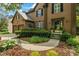 Charming two-story home featuring a well-manicured lawn and inviting entryway with lush landscaping and a two car garage at 3570 Bardfield Ct, Cumming, GA 30041