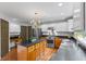 Well-lit kitchen with stainless appliances, island, and updated cabinets and counters at 3570 Bardfield Ct, Cumming, GA 30041