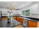 Well-lit kitchen with stainless appliances, island, and updated cabinets and counters at 3570 Bardfield Ct, Cumming, GA 30041