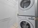 Stacked washer and dryer with shelving at 3570 Bardfield Ct, Cumming, GA 30041