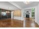 Spacious living room boasting hardwood floors, built in bookshelves, large windows, and a fireplace at 3570 Bardfield Ct, Cumming, GA 30041