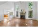 Bright living room featuring large windows, a fireplace, hardwood floors, and an open layout at 3570 Bardfield Ct, Cumming, GA 30041