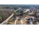 Aerial view showcasing multiple homesites among mature trees and a clear sky at 4410 Ross Estates Ct, Snellville, GA 30039