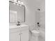 Bright bathroom featuring a modern vanity, sleek fixtures, and a shower-tub combo, offering a clean and stylish space at 4410 Ross Estates Ct, Snellville, GA 30039