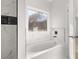 Modern bathroom features a luxurious soaking tub with a large window view at 4410 Ross Estates Ct, Snellville, GA 30039