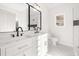 Modern bathroom with double vanity, marble countertops, and stylish lighting at 4410 Ross Estates Ct, Snellville, GA 30039