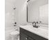 Bathroom with a vanity sink, white tile and a bathtub at 4410 Ross Estates Ct, Snellville, GA 30039