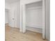 Bedroom with an open closet and wood flooring at 4410 Ross Estates Ct, Snellville, GA 30039