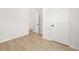 Bedroom with neutral colored walls and light-colored floors; closet is visible at 4410 Ross Estates Ct, Snellville, GA 30039