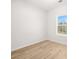 Bright bedroom with light wood floors and a window overlooking the landscape at 4410 Ross Estates Ct, Snellville, GA 30039