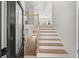 Home foyer features wood stairs with black metal railings and light hardwood floors throughout at 4410 Ross Estates Ct, Snellville, GA 30039