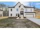 Front view of a two-story white home with a dark roof, covered entryway, and attached garage at 4410 Ross Estates Ct, Snellville, GA 30039
