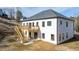 View of the rear of the home featuring a wood deck with stairs, large yard and bright siding and trim at 4410 Ross Estates Ct, Snellville, GA 30039