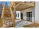 View of the rear of the home featuring a wood deck with stairs and a concrete patio for outdoor enjoyment at 4410 Ross Estates Ct, Snellville, GA 30039