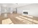 Bright and open living room features hardwood floors and a modern fireplace at 4410 Ross Estates Ct, Snellville, GA 30039
